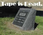 Picture of a gravestone with 'Tape' where the name would go. 'Tape Is Dead' is the caption. Audio Visual Consultants.